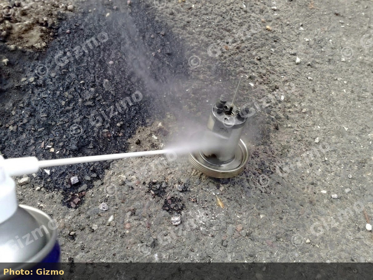 Spraying carb cleaner into a dual-carb piston
